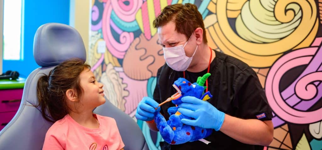 Pediatric dentist treating a child in Millcreek, UT near me.