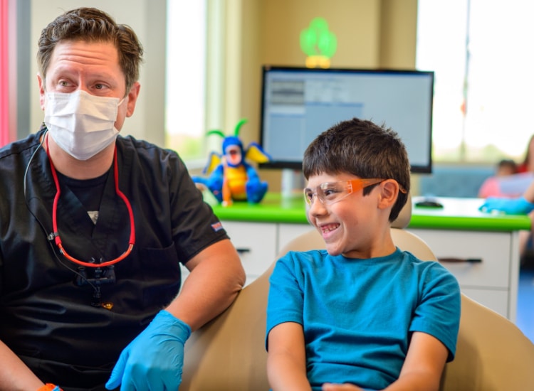 Smiling child receiving pediatric dental care in Holiday, UT near me.