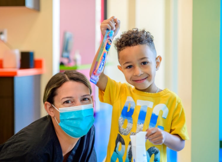 Smiling child receiving pediatric dental care in Holiday, UT