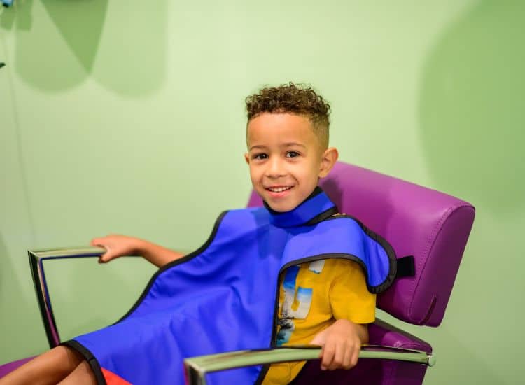 A smiling child receiving dental care at Kaleidoscope Kids Dentistry in Taylorsville, UT